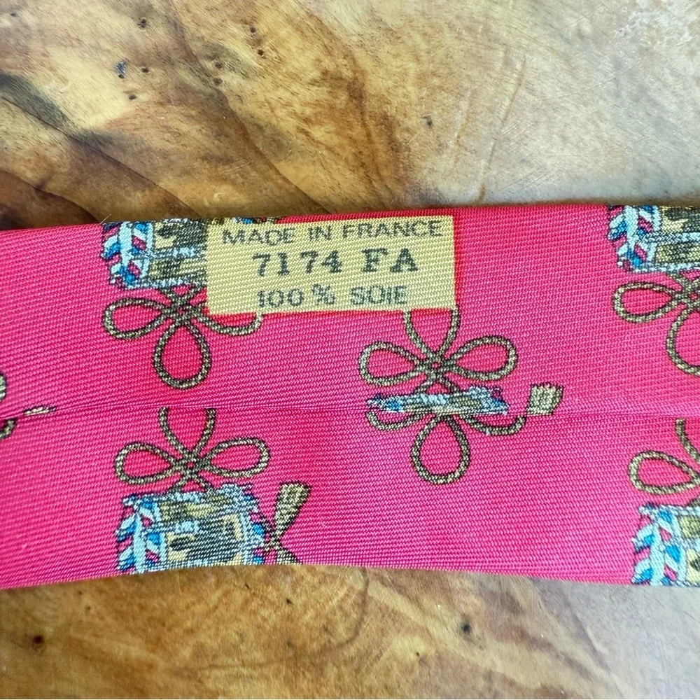 Vintage Hermès red silk tie with a repeating drum motif 3.5” x 54”